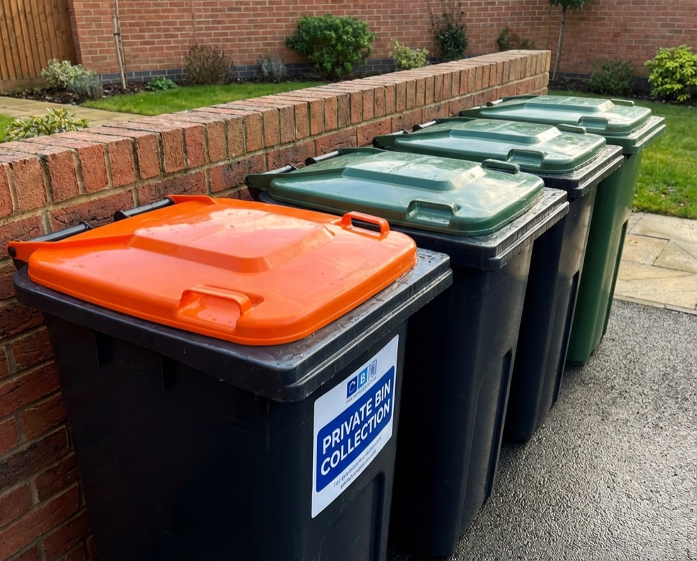 Recycling and general waste bins on a Felpham street